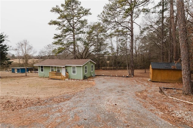 exterior space with a deck and a shed