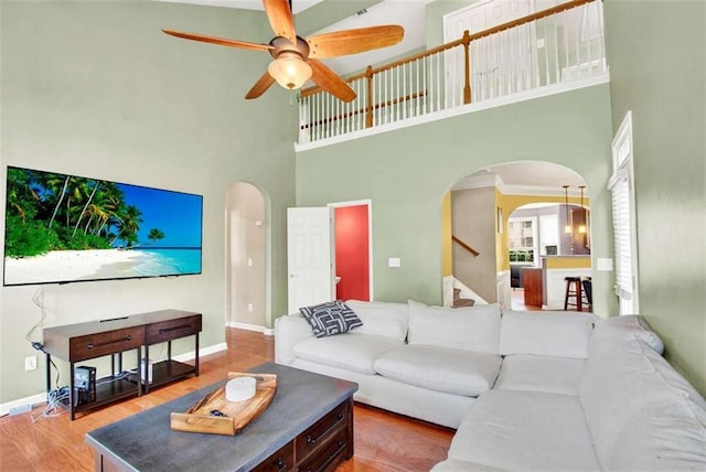 2685 Sardis Chase Ct, Buford, GA 30519 - living area featuring arched walkways, a high ceiling, ceiling fan, wood finished floors, and baseboards