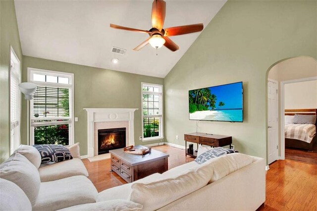 2685 Sardis Chase Ct, Buford, GA 30519 - living room with high vaulted ceiling, a premium fireplace, light wood-type flooring, a ceiling fan, and baseboards