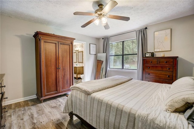151 Quail Hollow Dr, Dallas, GA 30157 - bedroom featuring light wood finished floors, a textured ceiling, a ceiling fan, and ensuite bath