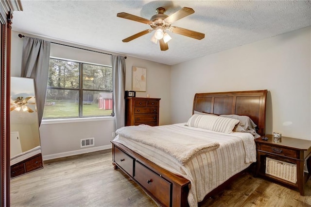 151 Quail Hollow Dr, Dallas, GA 30157 - bedroom featuring wood finished floors, a textured ceiling, and a ceiling fan
