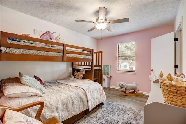 151 Quail Hollow Dr, Dallas, GA 30157 - bedroom featuring wood finished floors, a textured ceiling, and a ceiling fan