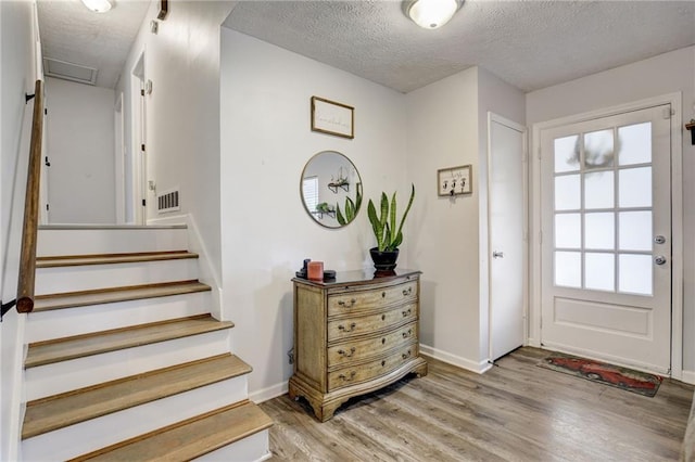 151 Quail Hollow Dr, Dallas, GA 30157 - entryway featuring a textured ceiling, light wood finished floors, and stairway