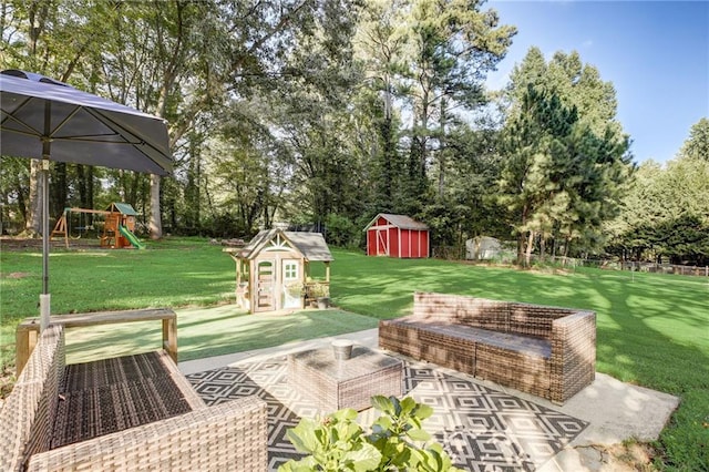 151 Quail Hollow Dr, Dallas, GA 30157 - view of green lawn featuring a storage unit, view of wooded area, a playground, and a patio area