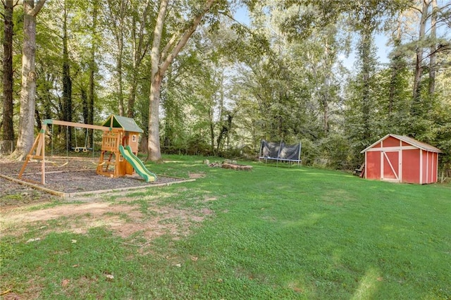 151 Quail Hollow Dr, Dallas, GA 30157 - view of grassy yard with a trampoline, a shed, a playground, and view of scattered trees