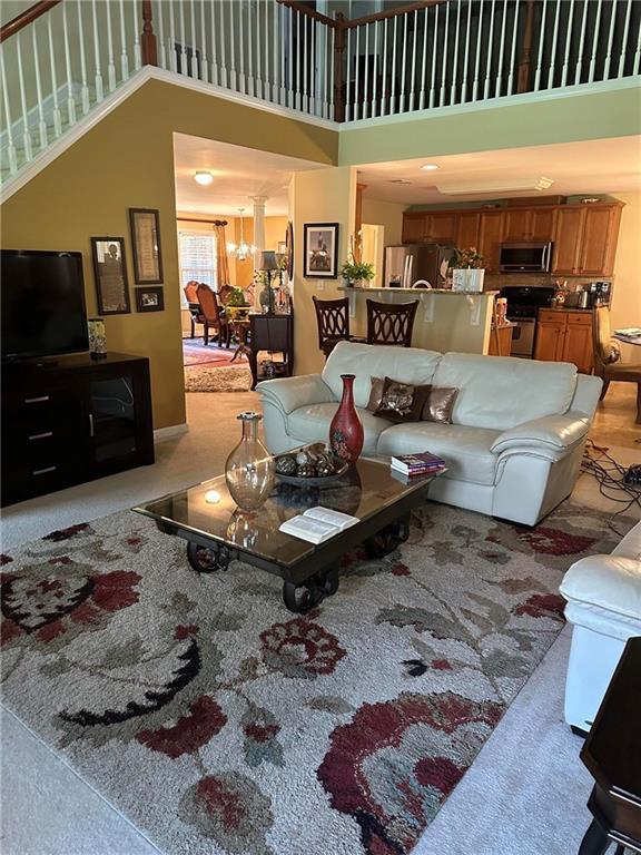 7946 Gossamer, Fairburn, GA 30213 - living area featuring a high ceiling and stairway