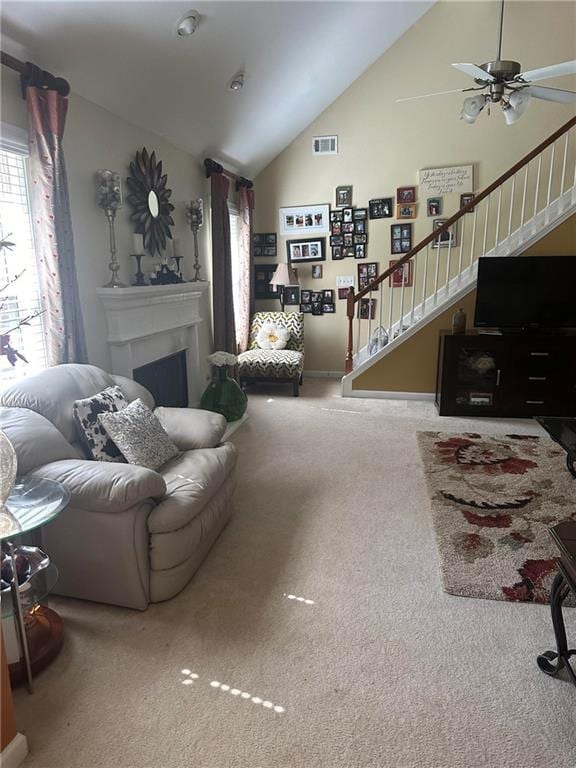 7946 Gossamer, Fairburn, GA 30213 - carpeted living area featuring stairway, lofted ceiling, a ceiling fan, and a fireplace