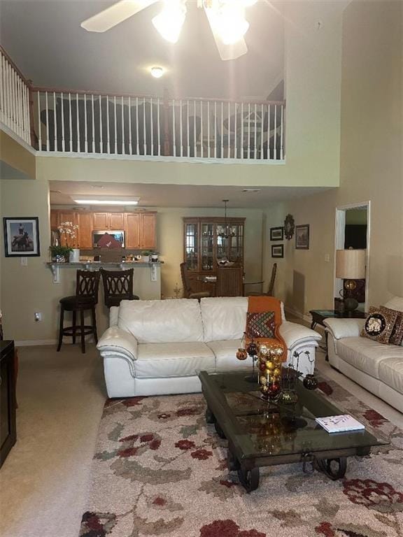 7946 Gossamer, Fairburn, GA 30213 - living area featuring a towering ceiling, ceiling fan, and light colored carpet