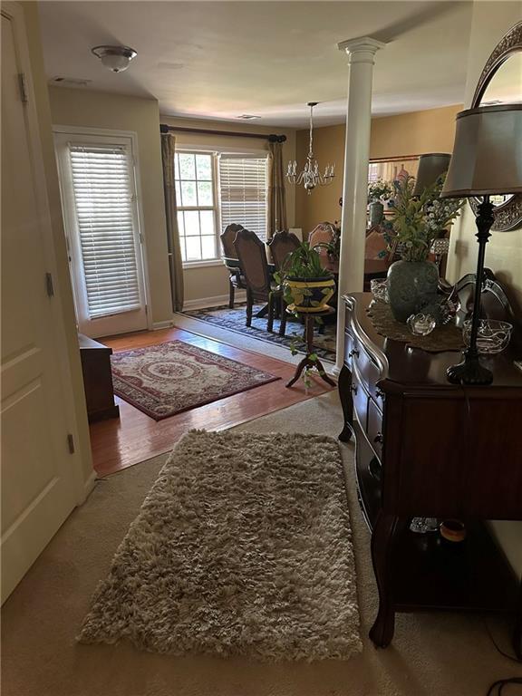 7946 Gossamer, Fairburn, GA 30213 - entrance foyer with a chandelier and ornate columns