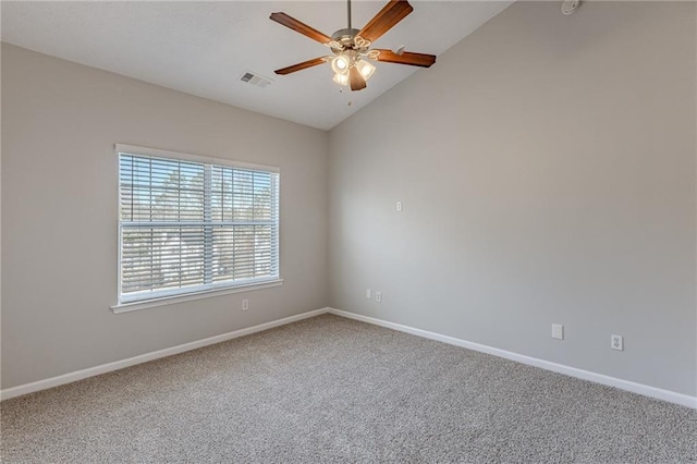 carpeted spare room featuring ceiling fan and lofted ceiling