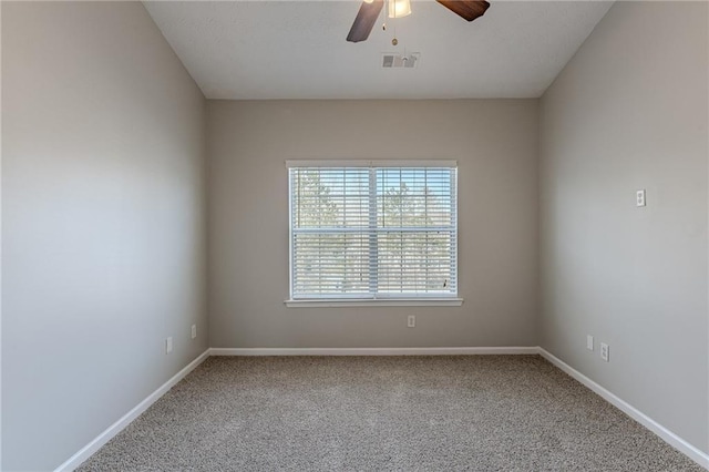 carpeted spare room with ceiling fan