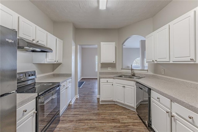 kitchen with sink, white cabinetry, black appliances, and a textured ceiling