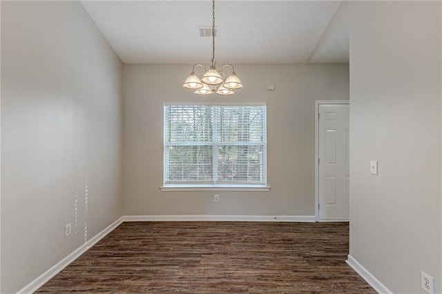 unfurnished dining area featuring dark wood-type flooring and an inviting chandelier