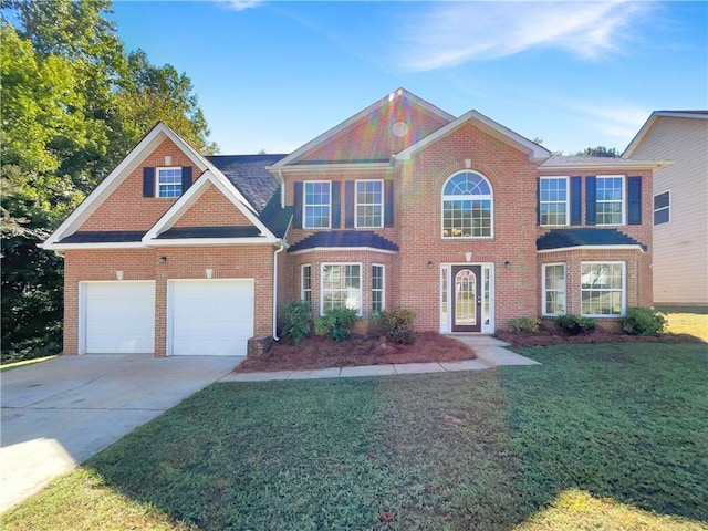 view of front of home with a garage and a front lawn