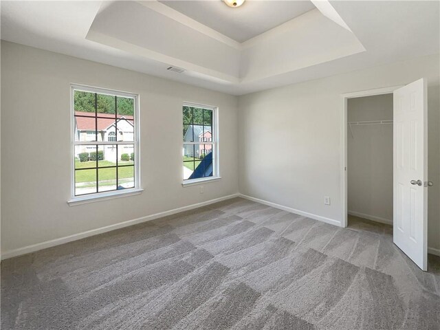 unfurnished room featuring dark colored carpet