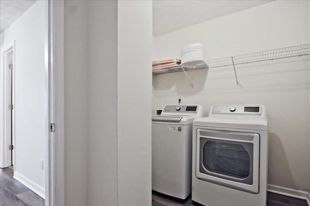 87 Davis Mill Ct, Lawrenceville, GA 30044 - laundry room with washing machine and dryer, dark wood-style flooring, baseboards, and a textured ceiling