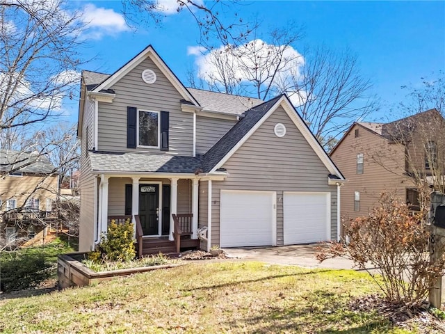 traditional-style home featuring a front yard, driveway, roof with shingles, an attached garage, and covered porch