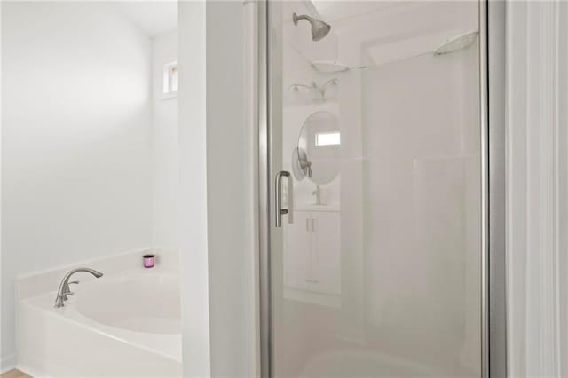 full bathroom with a stall shower and a garden tub