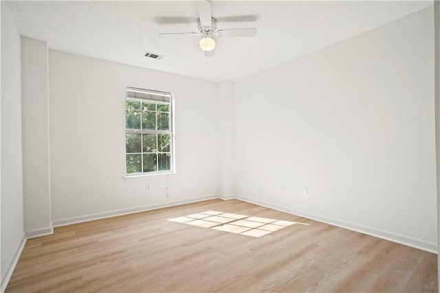 empty room with ceiling fan, visible vents, baseboards, and light wood-style flooring