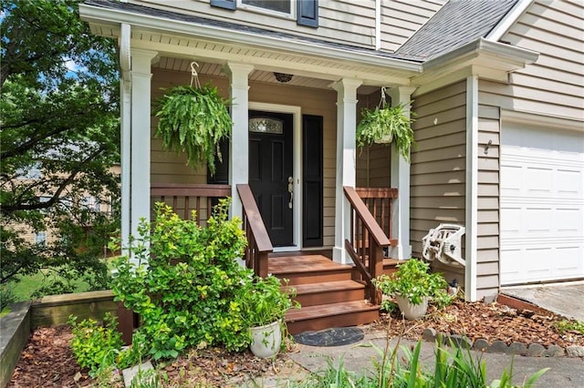 entrance to property featuring a porch and a garage