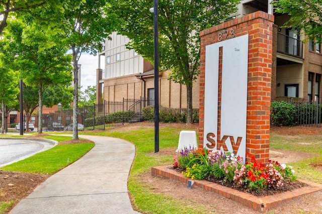 view of home's community featuring fence