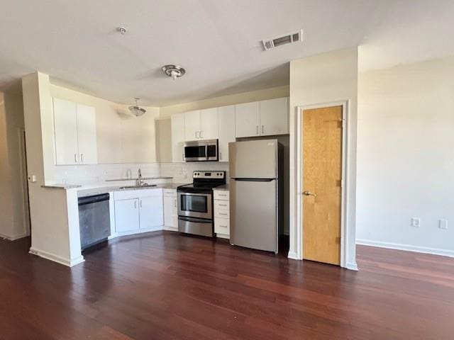 kitchen featuring visible vents, appliances with stainless steel finishes, light countertops, white cabinetry, and a sink