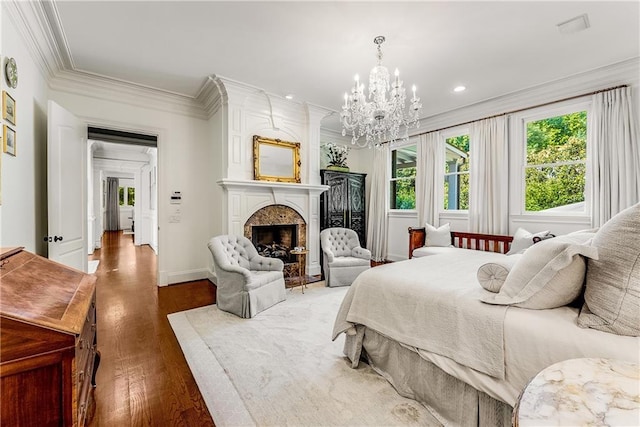 bedroom featuring a notable chandelier, a high end fireplace, ornamental molding, and wood-type flooring