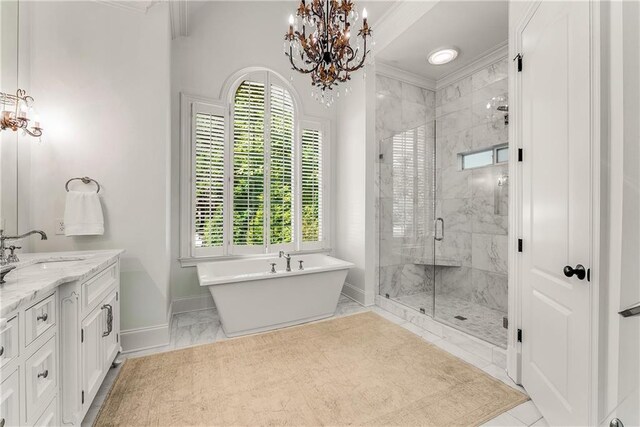 bathroom with ornamental molding, separate shower and tub, vanity, and an inviting chandelier