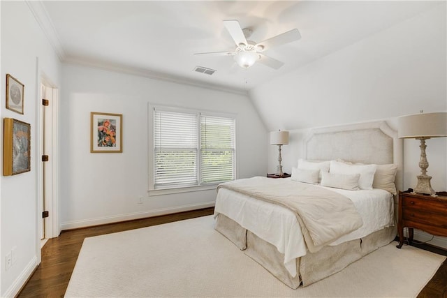 bedroom featuring crown molding, lofted ceiling, dark wood-type flooring, and ceiling fan