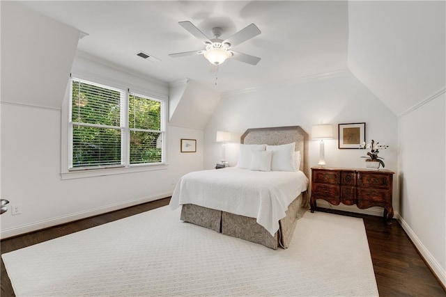 bedroom with dark hardwood / wood-style flooring, vaulted ceiling, and ceiling fan