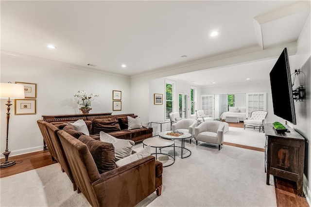 living room with crown molding and light hardwood / wood-style floors