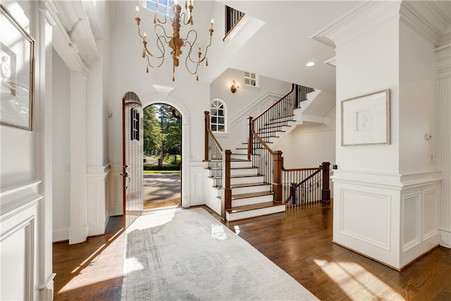 foyer entrance with dark hardwood / wood-style floors and a chandelier