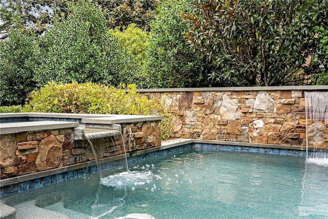 view of pool with pool water feature