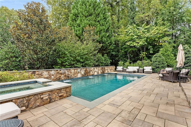 view of swimming pool with a patio, an outdoor living space, pool water feature, and an in ground hot tub