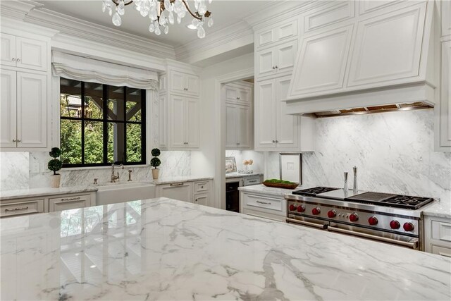 kitchen with sink, custom exhaust hood, white cabinetry, light stone counters, and double oven range