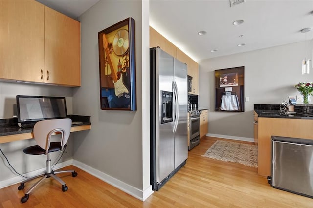 400 W Peachtree St NW Unit 3711, Atlanta, GA 30308 - kitchen featuring appliances with stainless steel finishes, light wood-style flooring, dark countertops, built in desk, and recessed lighting