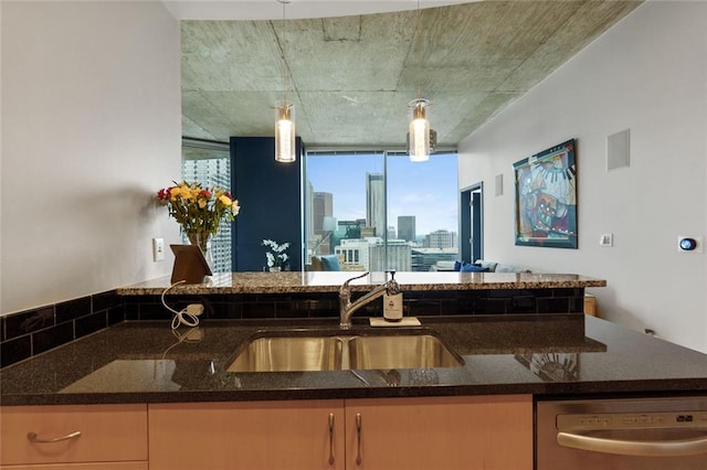 400 W Peachtree St NW Unit 3711, Atlanta, GA 30308 - kitchen featuring dishwasher, dark stone counters, decorative light fixtures, and a view of skyline
