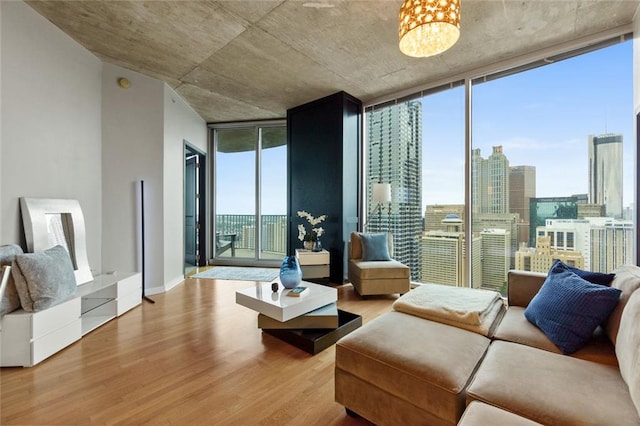 400 W Peachtree St NW Unit 3711, Atlanta, GA 30308 - living area with a wall of windows, wood finished floors, a chandelier, and a city view