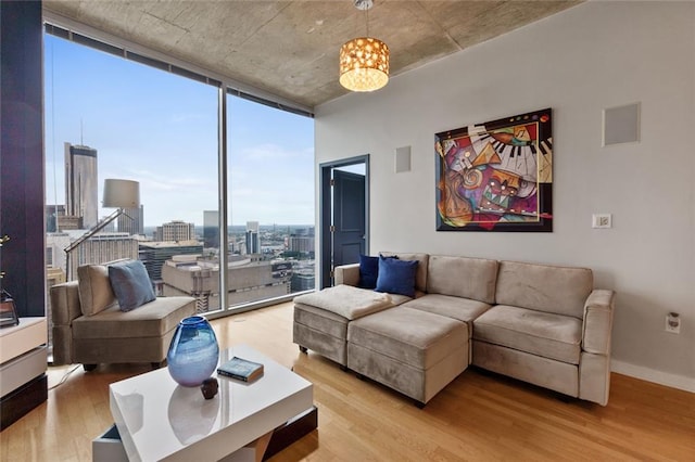400 W Peachtree St NW Unit 3711, Atlanta, GA 30308 - living area with wood finished floors, a chandelier, a wall of windows, and a view of city