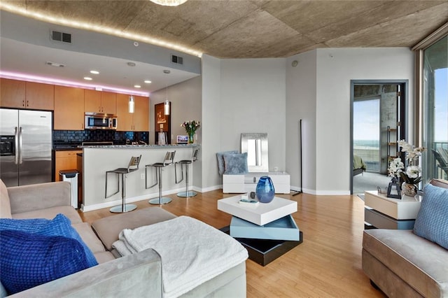 400 W Peachtree St NW Unit 3711, Atlanta, GA 30308 - living room featuring light wood finished floors and recessed lighting