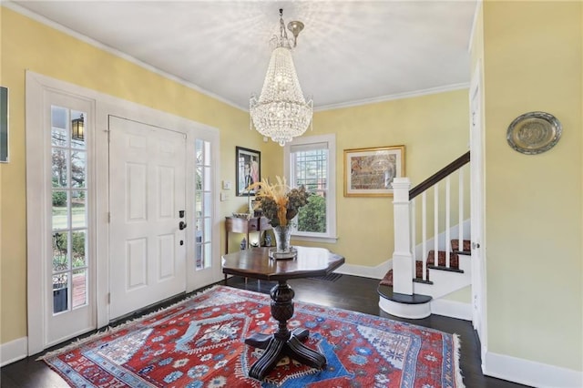 entrance foyer featuring crown molding, stairway, baseboards, and wood finished floors