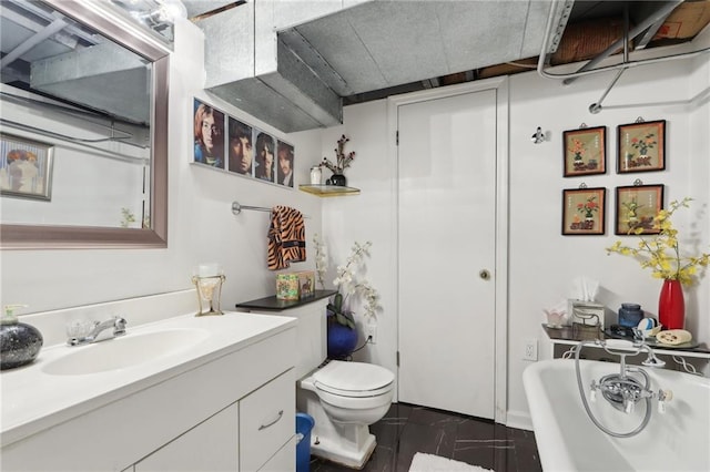 full bathroom with a tub to relax in, vanity, and toilet