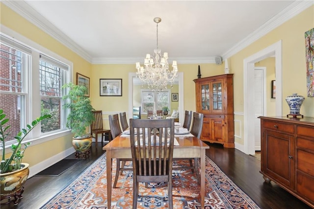 dining room with baseboards, visible vents, dark wood-style flooring, crown molding, and a chandelier