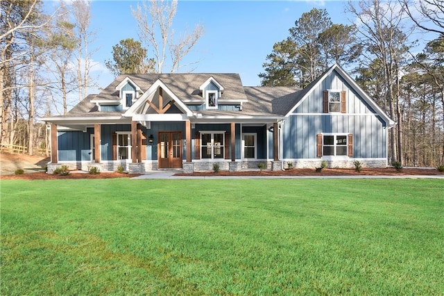 view of front of house with a front yard and covered porch