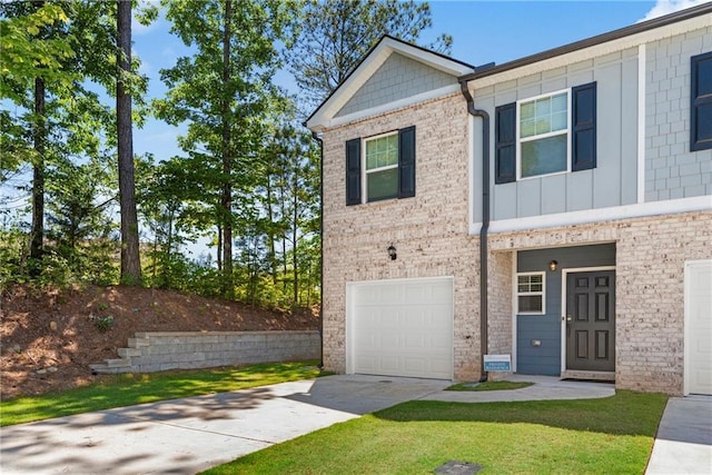 view of front of home with a front yard and a garage