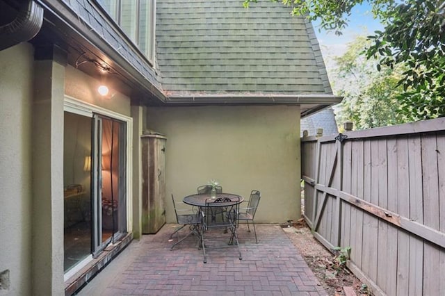 view of patio with outdoor dining space and fence