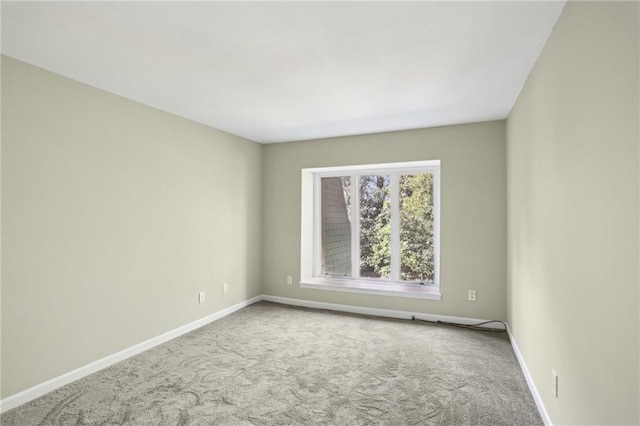 carpeted spare room with baseboards