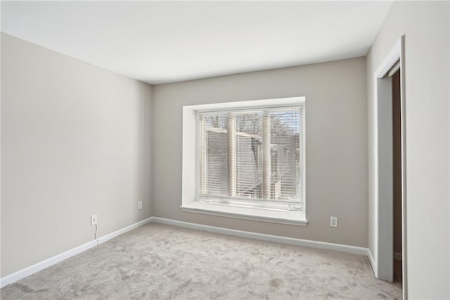 empty room with carpet and baseboards