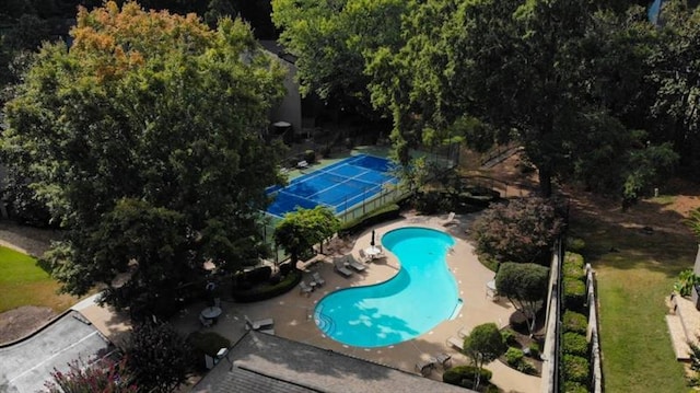 view of swimming pool featuring a patio area and fence