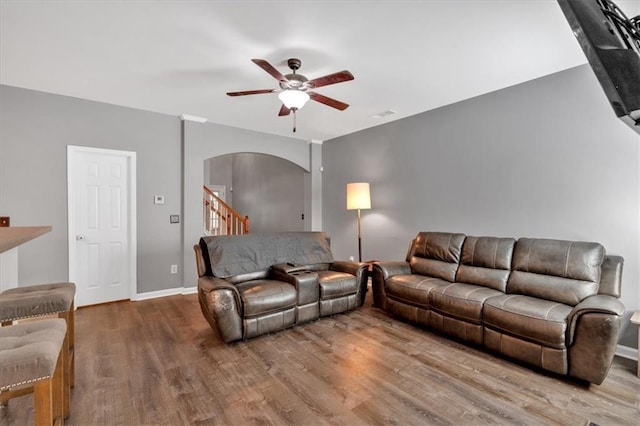 4349 Kousa Rd Unit 4, Austell, GA 30106 - living area featuring arched walkways, ceiling fan, wood finished floors, and stairs